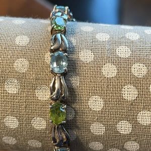 Silver tennis bracelet with blue topaz and peridot gemstones